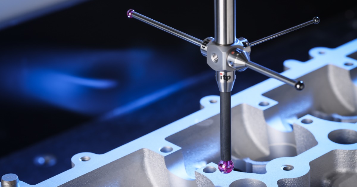 A measurement stylus contacting a machined metal engine component with circular openings and bright blue lighting.